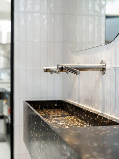 Bealstone-coated bathroom vanity, showcasing its customizable color and unique mineral appearance in a high-end setting.