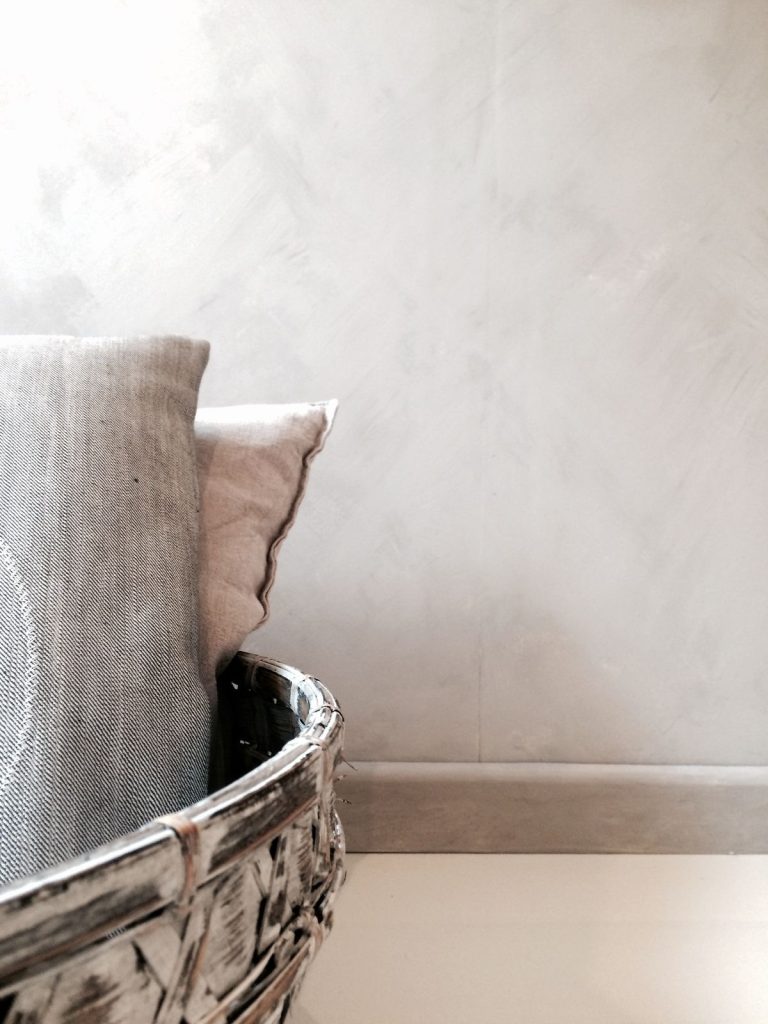 Kalklitir lime paint on a subtly textured wall in earthy tones, creating a warm, natural ambiance.