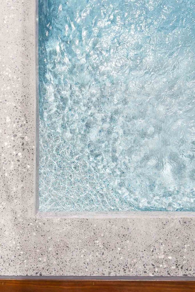Marblepool finish on a pool surface, highlighting its luxurious micro-terrazzo texture.