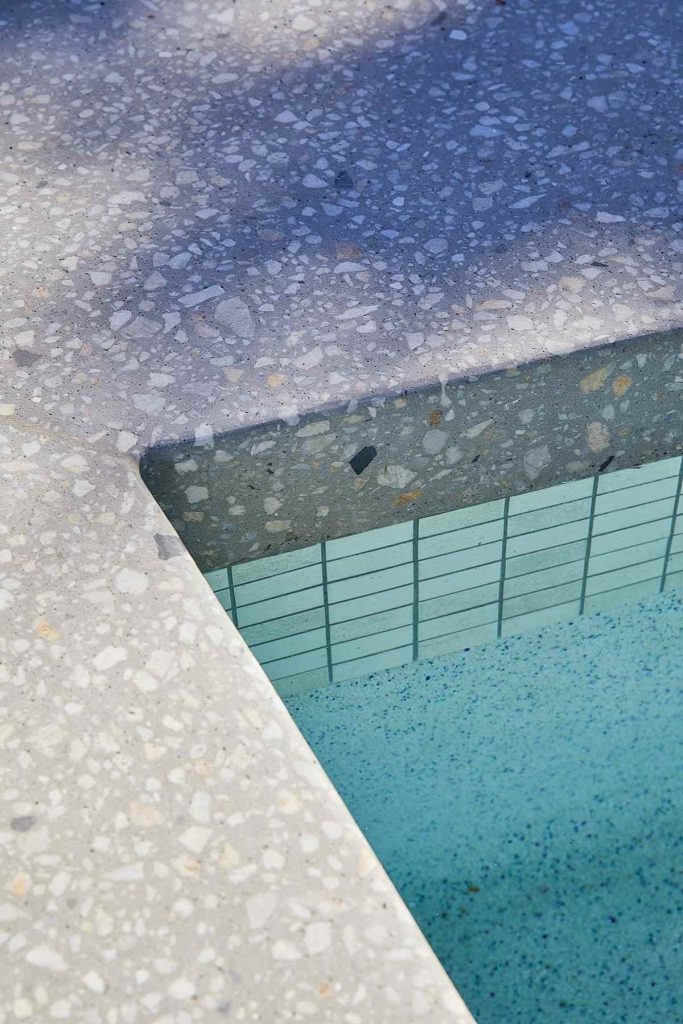 Marblepool finish on a swimming pool surface, showcasing its luxurious micro-terrazzo texture.