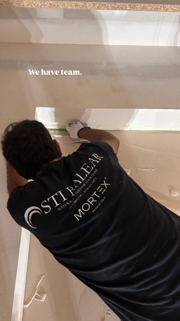 Artisanal Mortex application on a custom built-in cabinet within a minimalist commercial space.