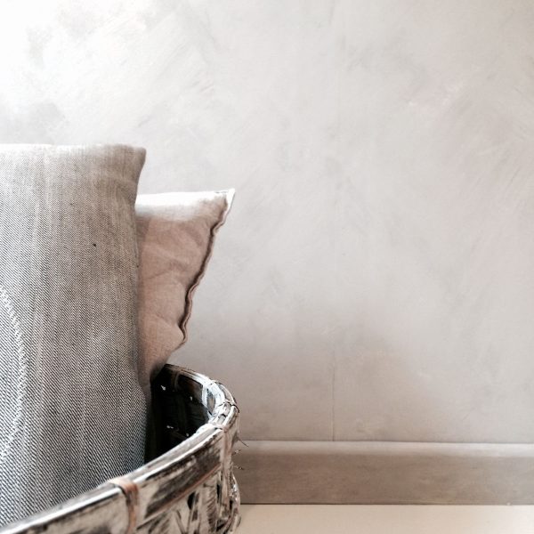 Kalklitir lime paint on a subtly textured wall in earthy tones, creating a warm, natural ambiance.
