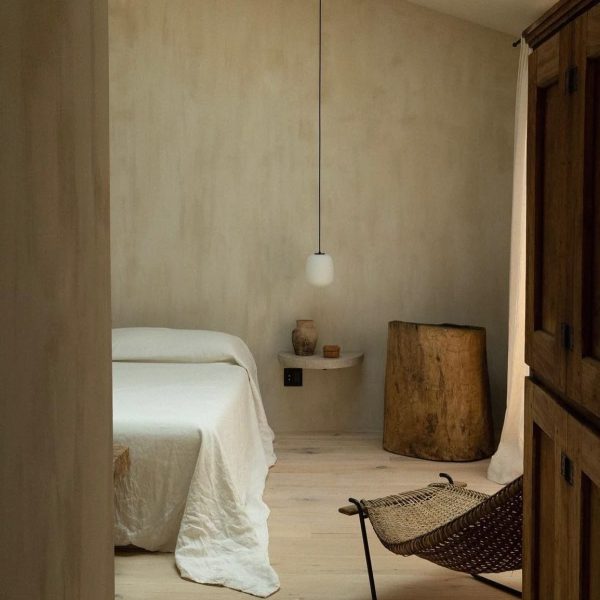 Kalklitir lime paint on a subtly textured wall in earthy tones, creating a warm, natural ambiance.