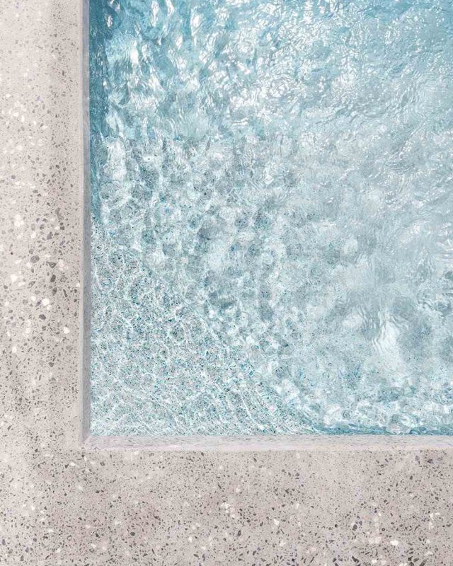 Marblepool finish on a pool surface, highlighting its luxurious micro-terrazzo texture.