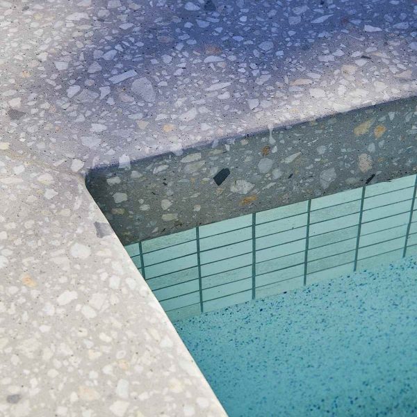 Marblepool finish on a swimming pool surface, showcasing its luxurious micro-terrazzo texture.