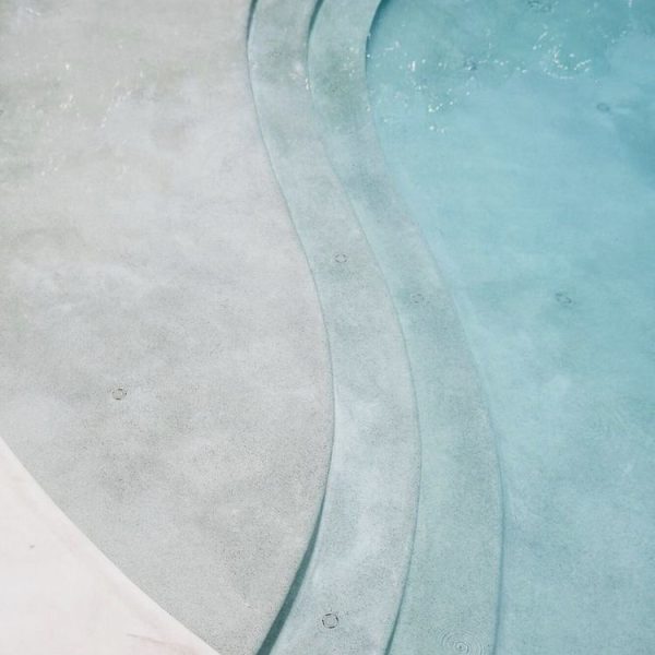 Marblepool finish on a swimming pool surface, showcasing its luxurious micro-terrazzo texture.