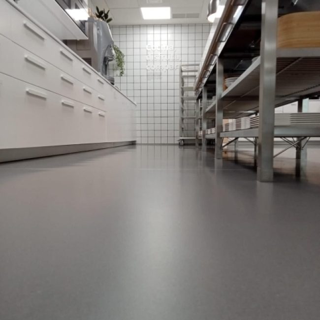 Seamless epoxy resin floor in a high-traffic industrial facility, showcasing its durability.