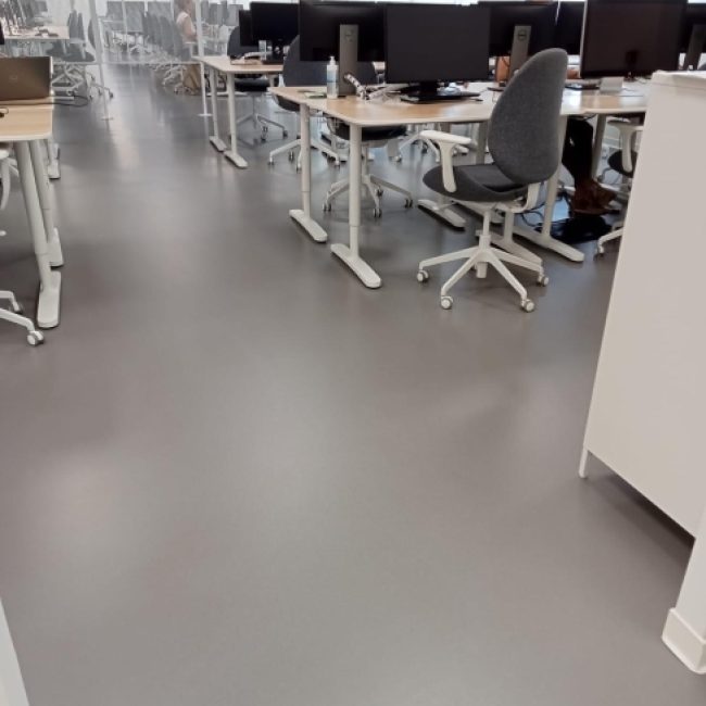 Seamless epoxy resin floor in a high-traffic industrial facility, showcasing its durability.