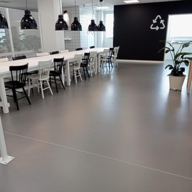 Seamless epoxy resin floor in a high-traffic industrial facility, showcasing its durability.