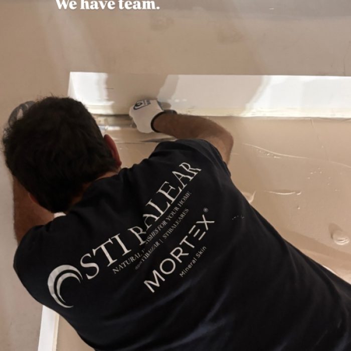 Artisanal Mortex application on a custom built-in cabinet within a minimalist commercial space.