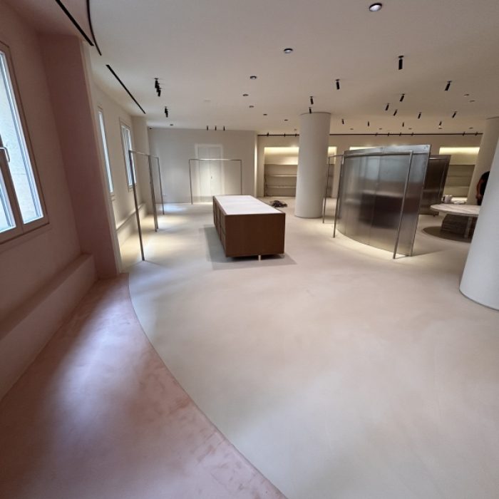 Artisanal Mortex application on a custom built-in cabinet within a minimalist commercial space.