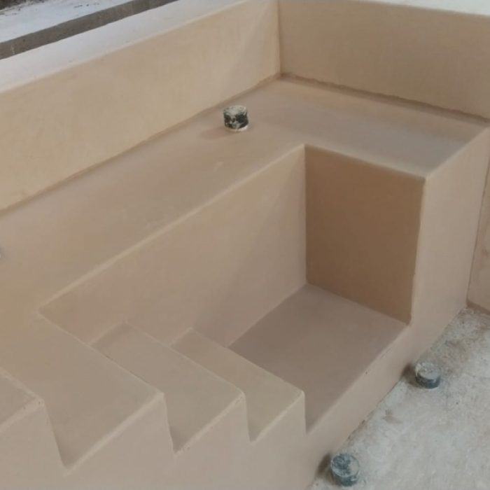 Close-up of seamless Chukum-coated steps inside a renovated courtyard plunge pool.