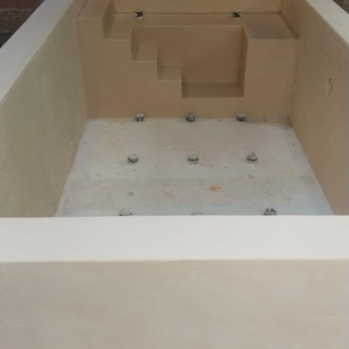Close-up of seamless Chukum-coated steps inside a renovated courtyard plunge pool.