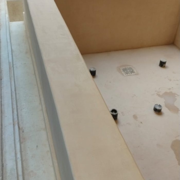 Close-up of seamless Chukum-coated steps inside a renovated courtyard plunge pool.